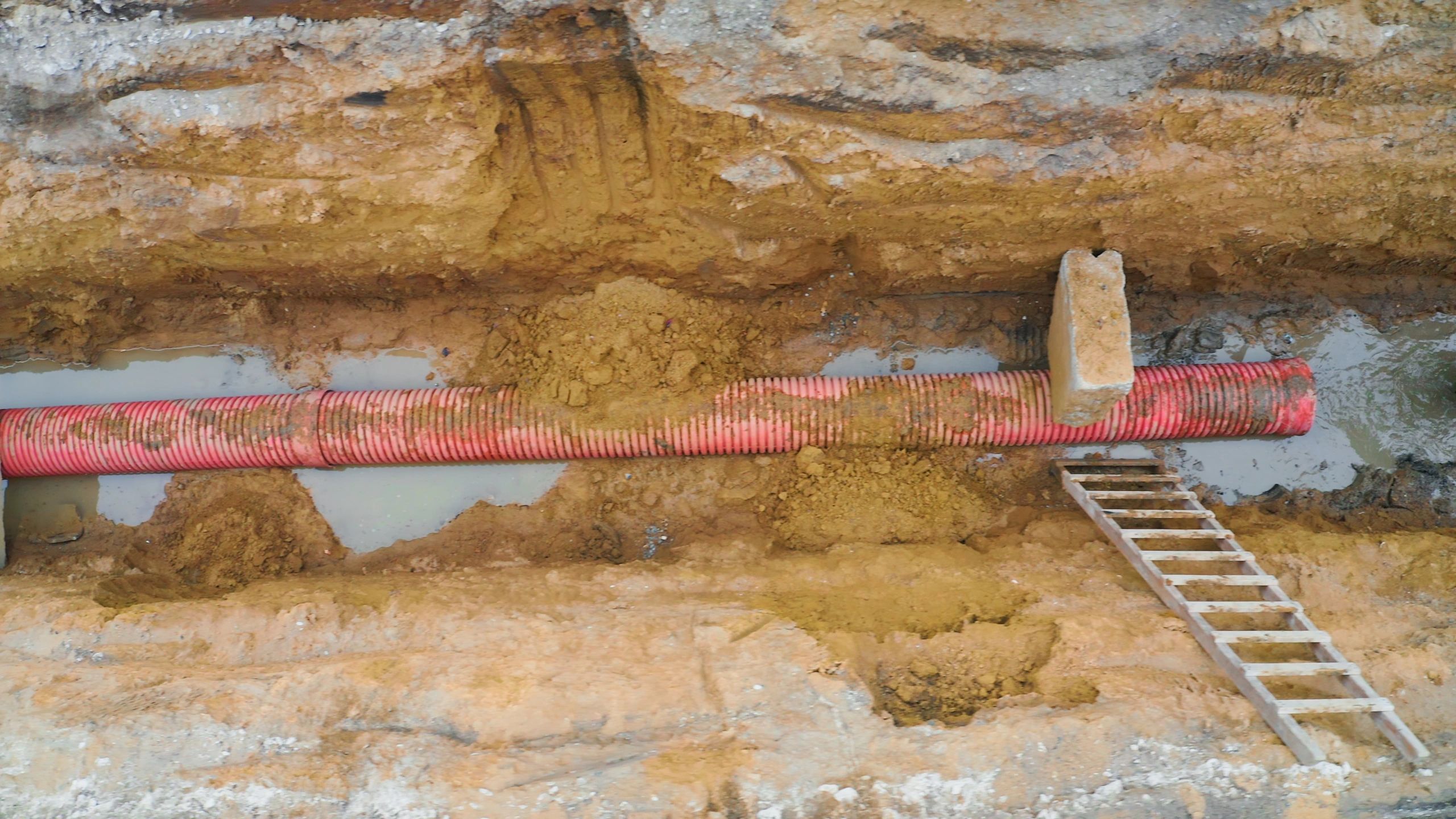 Utility pipe placed in a trench during installation