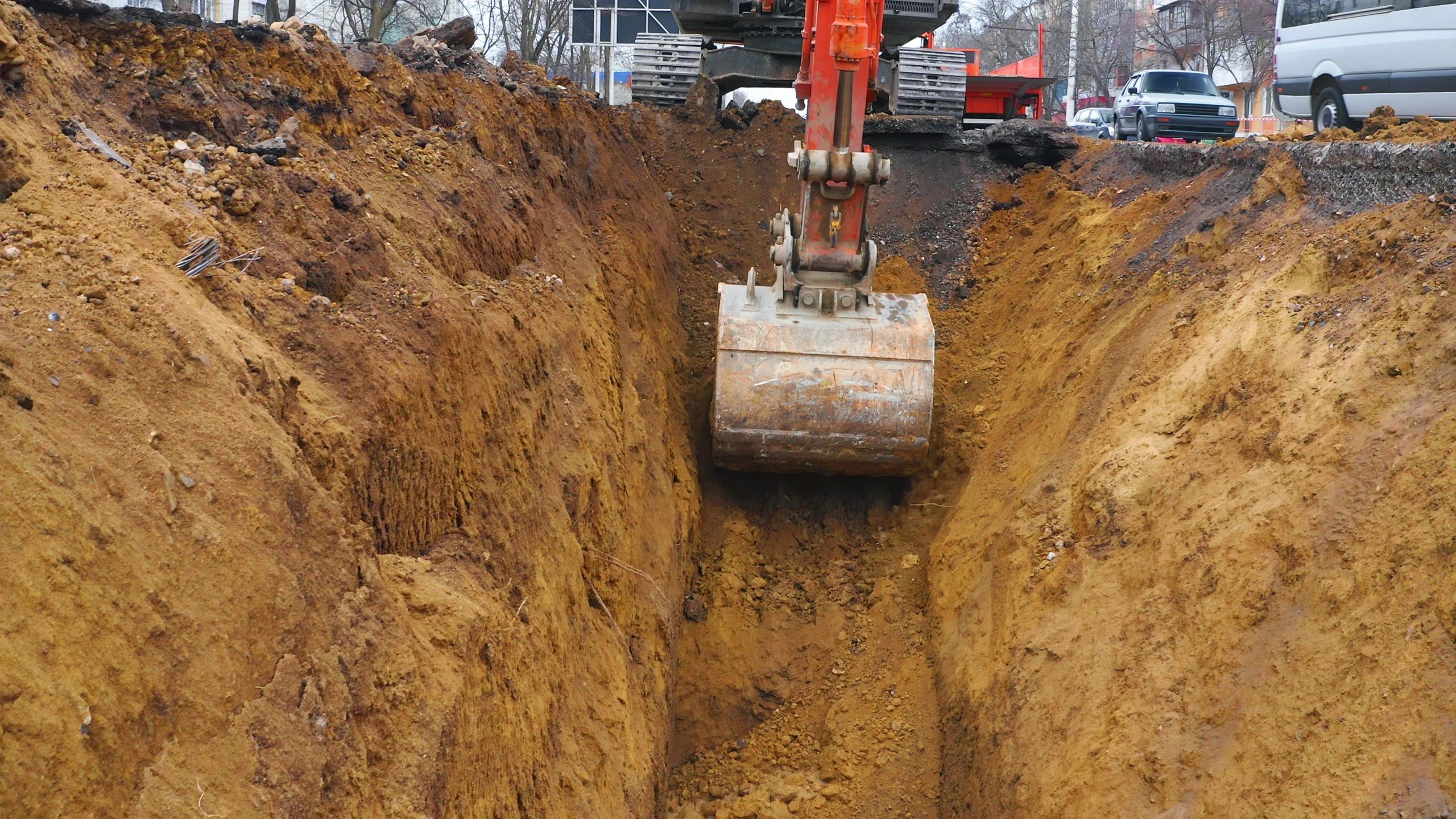 Excavator digging a trench on a construction site